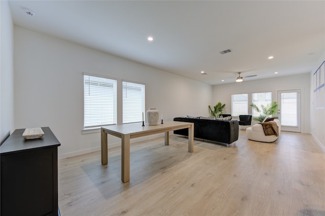 living room featuring ceiling fan and light hardwood / wood-style flooring