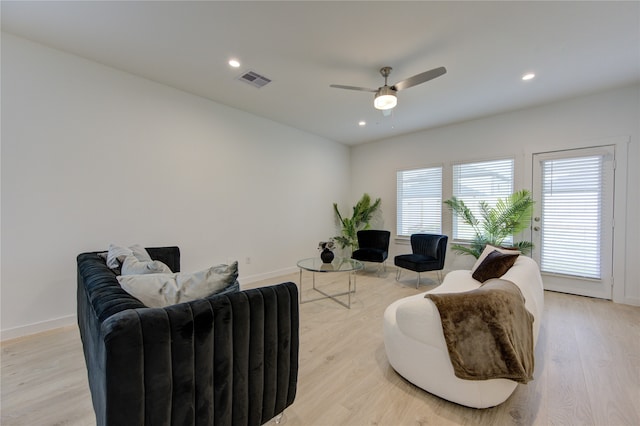 living room with ceiling fan and light wood-type flooring