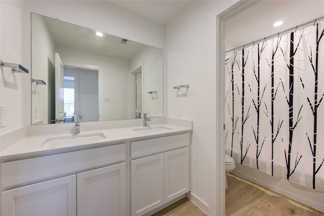 full bathroom with shower / bath combo with shower curtain, toilet, wood-type flooring, and vanity