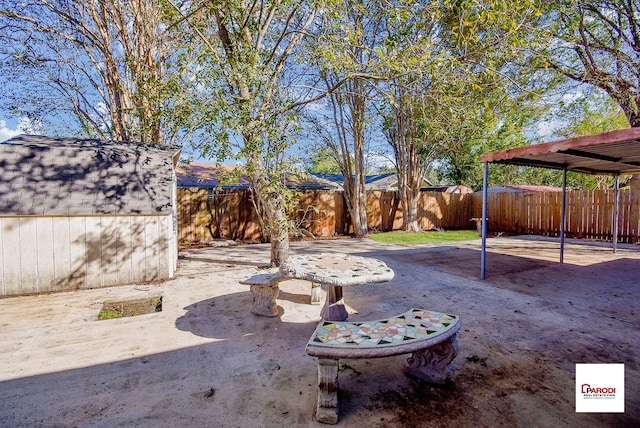 view of yard with a storage shed and a patio area