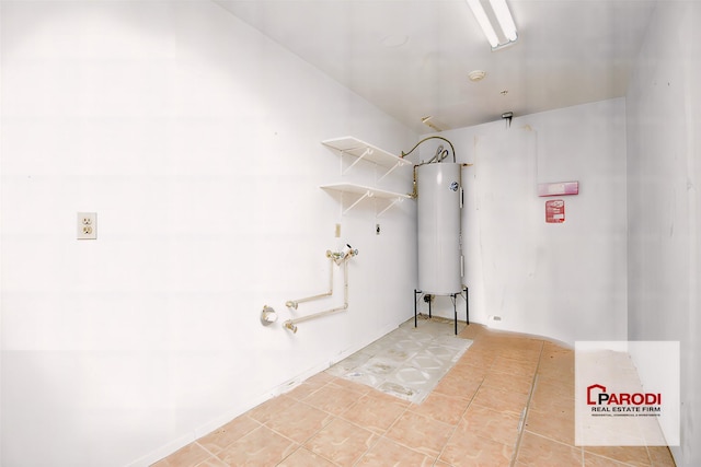 clothes washing area featuring water heater