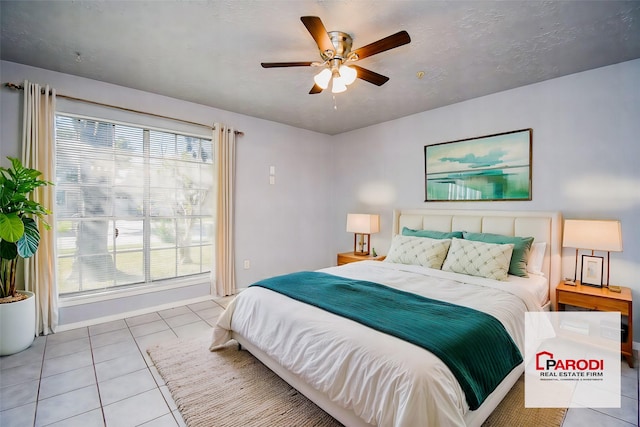 bedroom with ceiling fan and light tile patterned floors