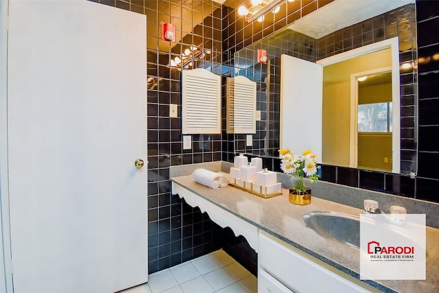 bathroom featuring tile walls, tile patterned floors, and vanity