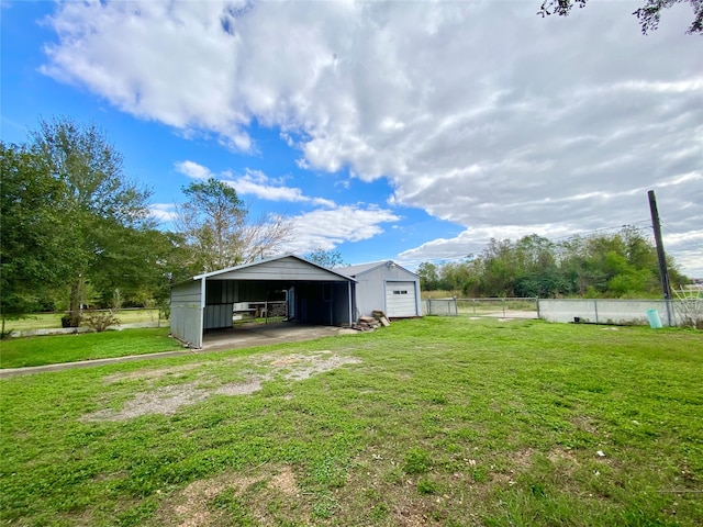 view of yard with a carport and an outdoor structure