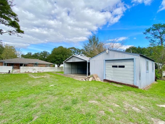 view of outbuilding with a carport and a lawn