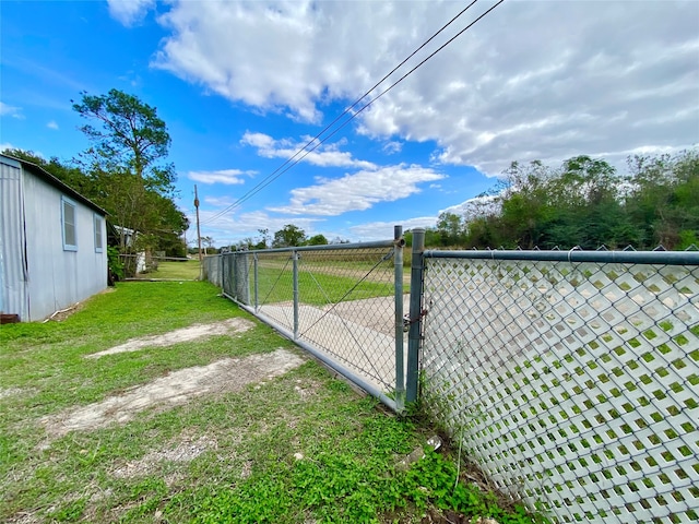 view of gate featuring a lawn