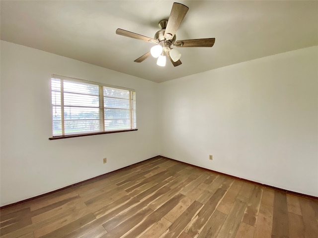 unfurnished room with hardwood / wood-style flooring and ceiling fan