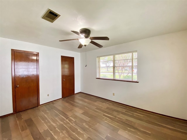 unfurnished bedroom with ceiling fan and hardwood / wood-style flooring