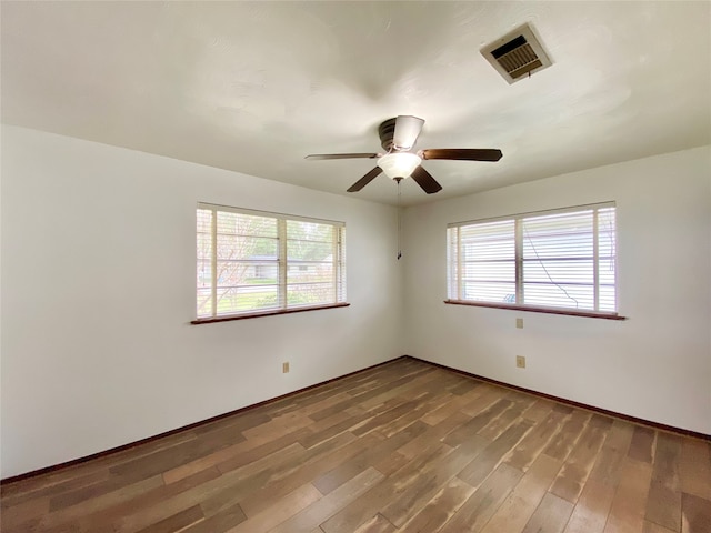 spare room featuring ceiling fan and hardwood / wood-style flooring