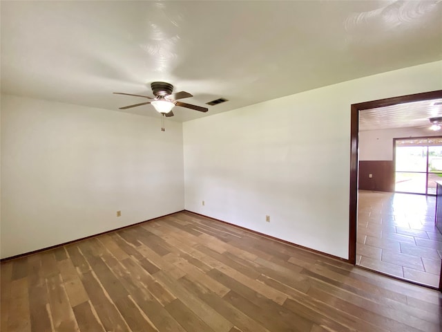 empty room featuring wood-type flooring and ceiling fan