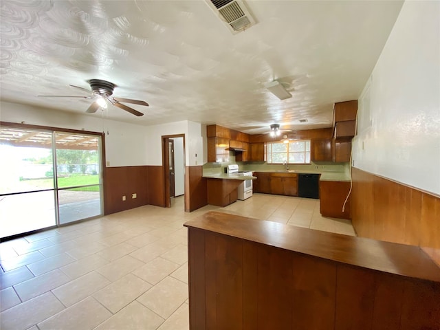 kitchen with sink, black dishwasher, kitchen peninsula, light tile patterned floors, and white stove