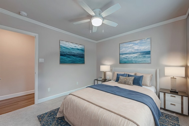 carpeted bedroom with ceiling fan and ornamental molding