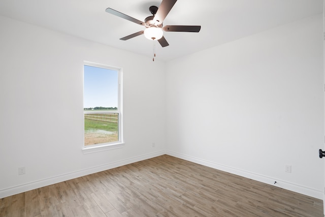 spare room with ceiling fan and light hardwood / wood-style flooring