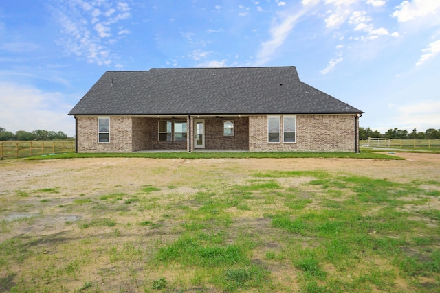 rear view of property featuring a yard