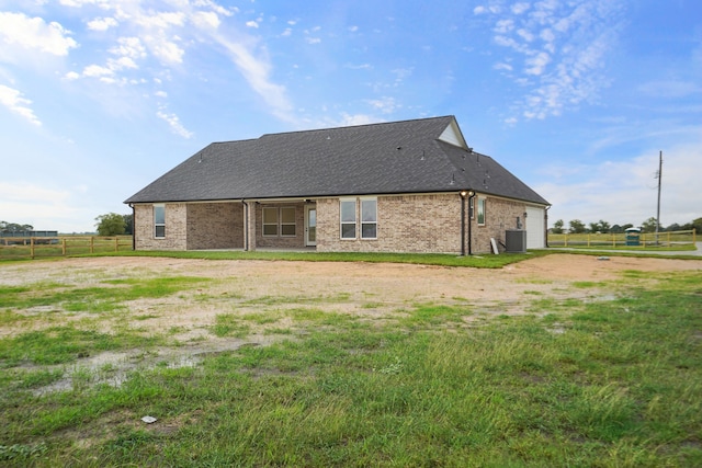 back of house with central AC