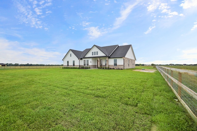 view of front of home featuring a front yard and a rural view