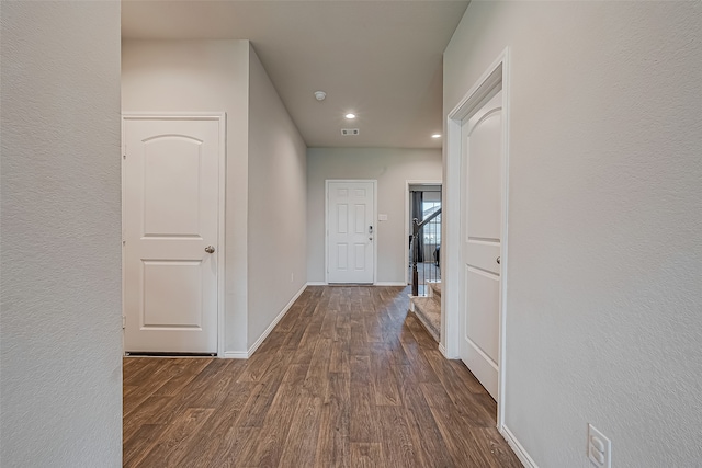 hallway with dark hardwood / wood-style floors