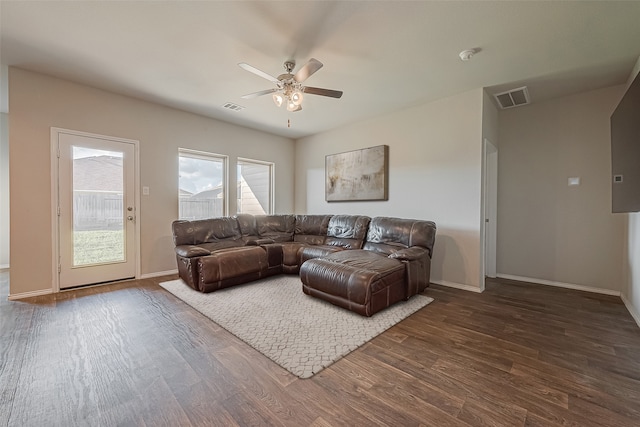 living room with dark hardwood / wood-style floors and ceiling fan