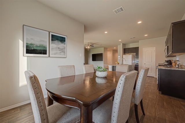 dining room featuring dark hardwood / wood-style floors and ceiling fan