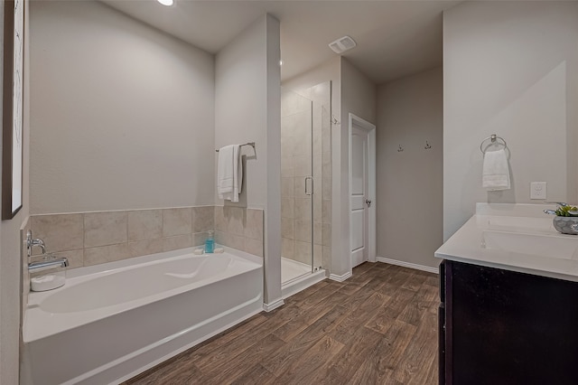 bathroom featuring wood-type flooring, vanity, and independent shower and bath