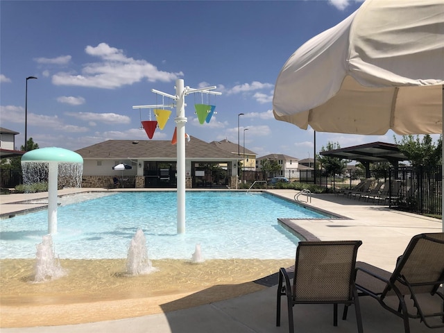 view of pool featuring pool water feature and a patio area