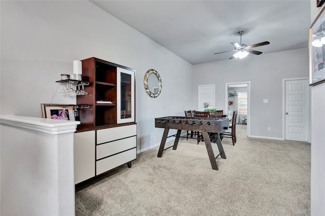 dining room with light carpet and ceiling fan