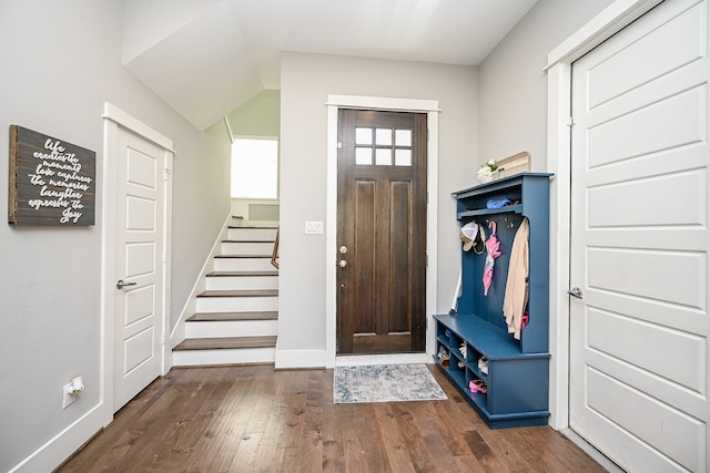 foyer featuring dark hardwood / wood-style flooring and vaulted ceiling