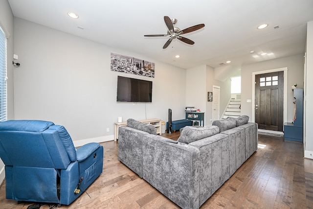 living room featuring hardwood / wood-style flooring and ceiling fan