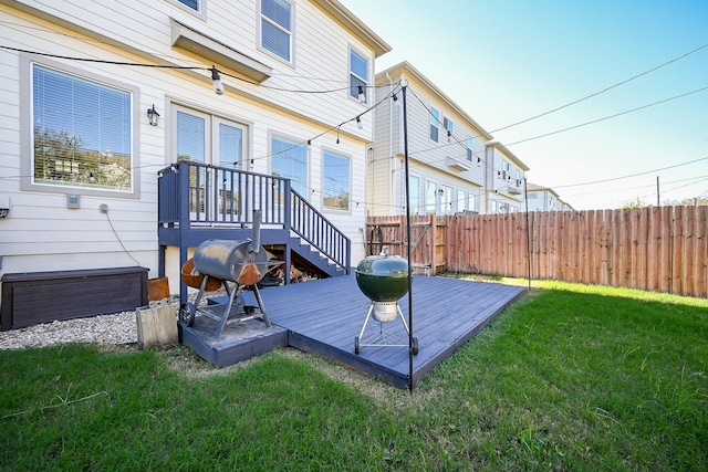 wooden deck featuring a lawn