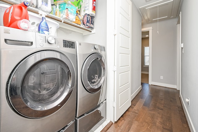 washroom featuring dark hardwood / wood-style flooring and washing machine and clothes dryer