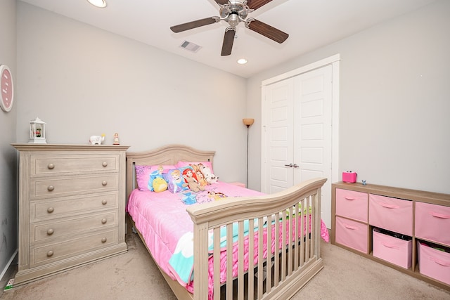 carpeted bedroom featuring a closet and ceiling fan