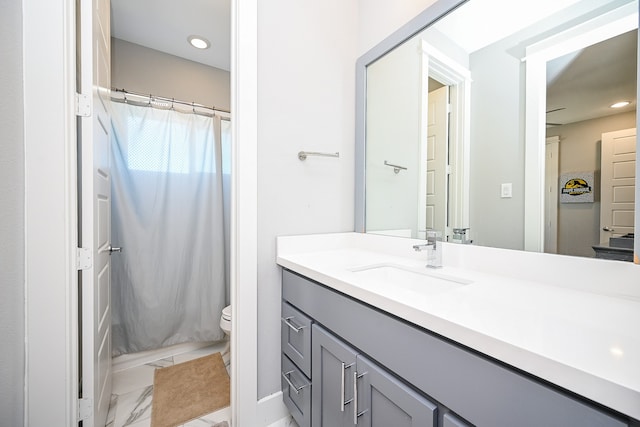 bathroom featuring vanity, toilet, and walk in shower