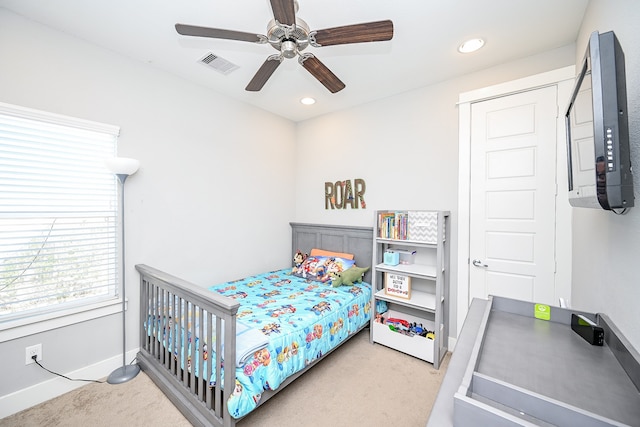 bedroom with light carpet and ceiling fan