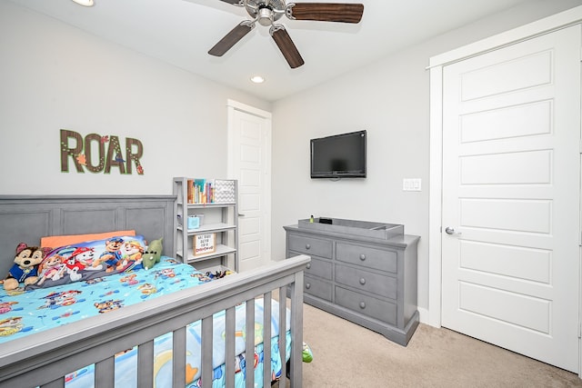 bedroom featuring ceiling fan and light carpet