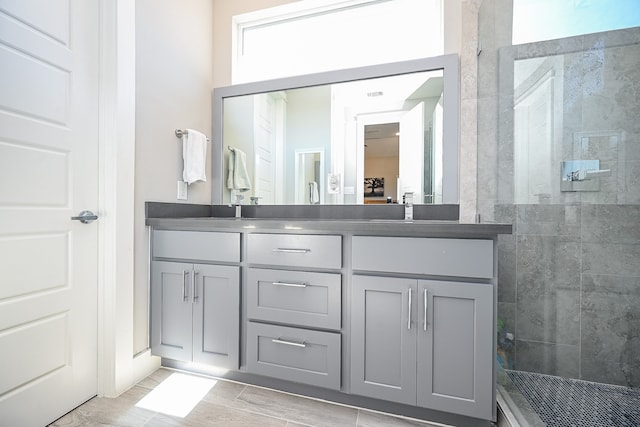 bathroom featuring vanity and a tile shower