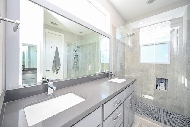 bathroom featuring vanity and a shower with door