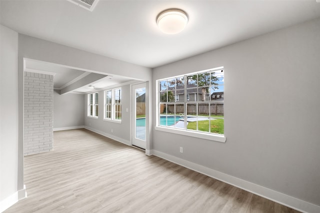 spare room featuring light wood-type flooring