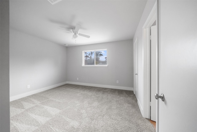 carpeted spare room with ceiling fan