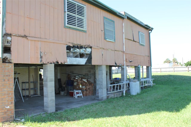 back of house with a yard and fence