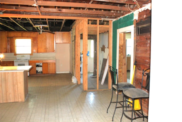 interior space featuring electric stove and tile patterned floors