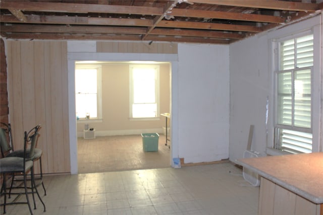 interior space featuring light floors and wood walls