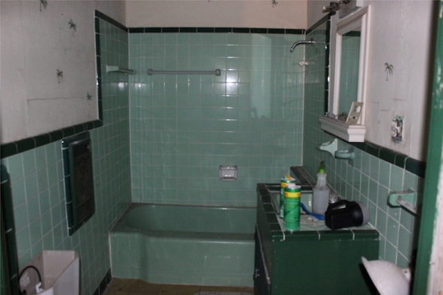 bathroom with toilet, vanity, tile walls, and bathing tub / shower combination