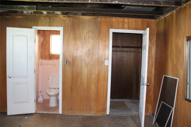 unfurnished bedroom with wood walls