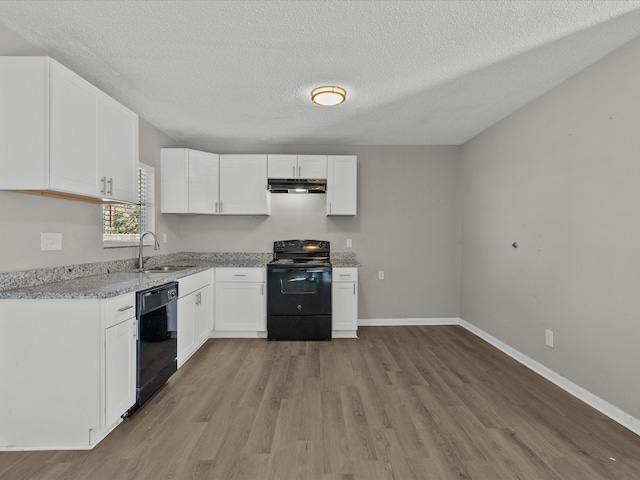 kitchen with light wood-type flooring, a textured ceiling, sink, black appliances, and white cabinets