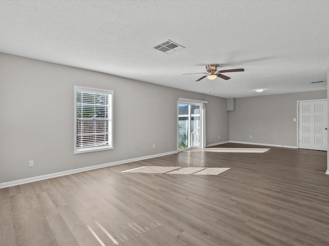 unfurnished room featuring ceiling fan, light hardwood / wood-style flooring, and a textured ceiling