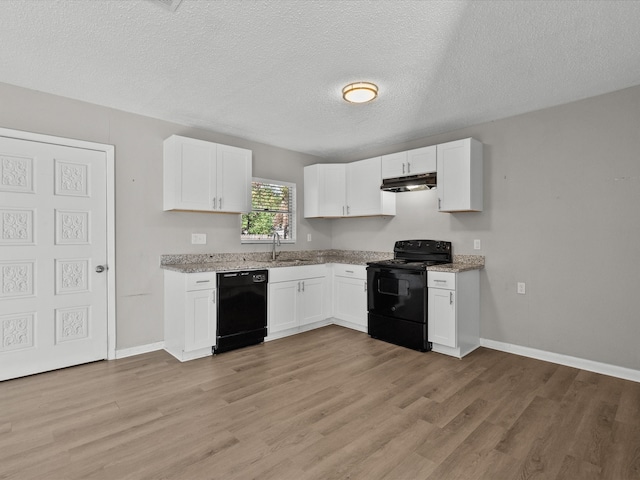 kitchen featuring sink, a textured ceiling, white cabinets, black appliances, and light wood-type flooring