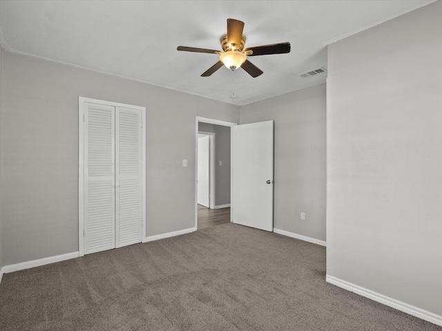 unfurnished bedroom with ceiling fan, a closet, and carpet