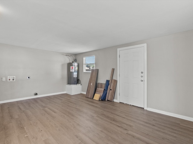 empty room featuring light hardwood / wood-style floors and water heater