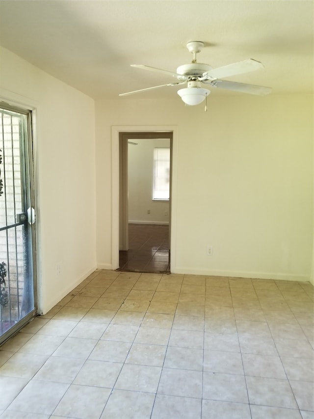 tiled empty room with ceiling fan