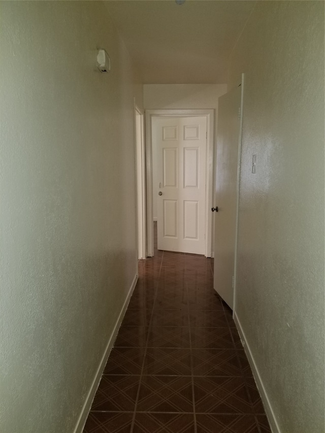 corridor with dark tile patterned flooring